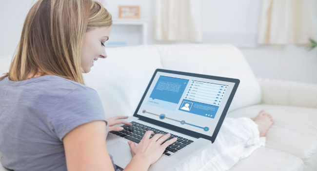 Woman Checking Social Media Profile with Her Laptop