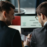 Two Young Businessman Having Successful Meeting