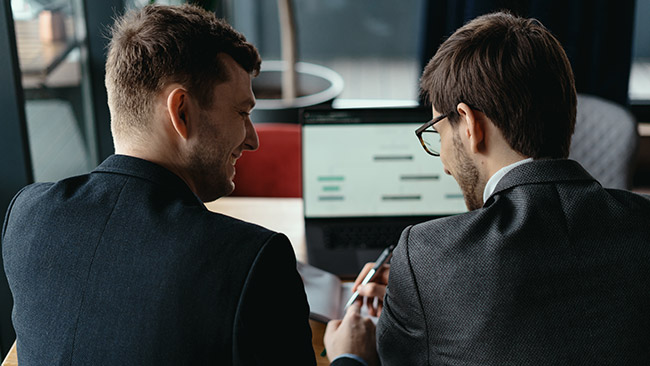 Two Young Businessman Having Successful Meeting