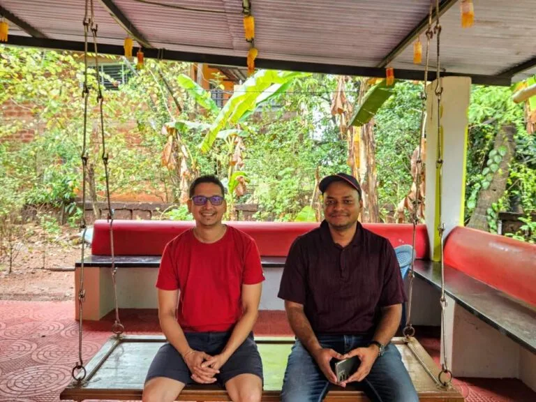 Rajesh Namase and Tushar Thakur sitting together on a swing